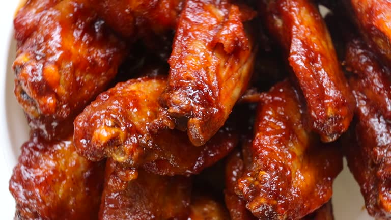Bowl of Buffalo Wings with red and spicy sauce